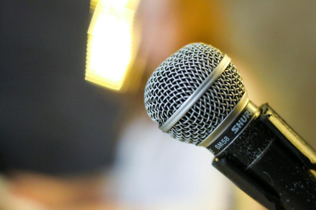 A detailed view of a Shure SM58 microphone, ideal for recording and live performances. Perfect for audio enthusiasts.